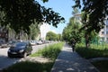 passage on the street for pedestrians with car parking in the summer in the city