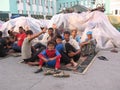 people refugees sitting at the train station homeless waiting for help migrants