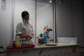 a scientist, a woman in a white coat, and a boy student show their experience in a laboratory with