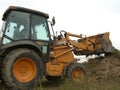 Russia, Novosibirsk, September 18, 2012: large powerful tractor grader rakes the ground running bucket on the construction site