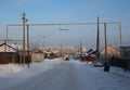 street in the village in winter in a Siberian village with houses residents in the snow on the