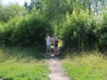 Two girls friends walking on the street go through the Park