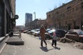 A woman with a child mother go for a walk on the street in the city in the spring