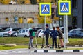 Russia - October 2019: A group of children on Kick scooter at a pedestrian crossing over a highway