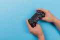 Russia, OKTOBER 24 2019: Male hands holding a PS4 controller, Sony PlayStation 4 game console Royalty Free Stock Photo