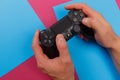 Russia, OKTOBER 24 2019: Male hands holding a PS4 controller, Sony PlayStation 4 game console Royalty Free Stock Photo