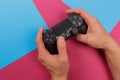 Russia, OKTOBER 24 2019: Male hands holding a PS4 controller, Sony PlayStation 4 game console Royalty Free Stock Photo