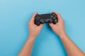 Russia, OKTOBER 24 2019: Male hands holding a PS4 controller, Sony PlayStation 4 game console Royalty Free Stock Photo