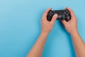 Russia, OKTOBER 24 2019: Male hands holding a PS4 controller, Sony PlayStation 4 game console Royalty Free Stock Photo