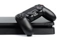 Russia, OKTOBER 24 2019: Sony PlayStation 4 game console and controller, closeup on a white background. - Image Royalty Free Stock Photo