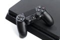 Russia, OKTOBER 24 2019: Sony PlayStation 4 game console and controller, closeup on a white background. - Image Royalty Free Stock Photo