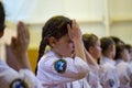 Russia. Penza. Demonstration classes in karate. The girl wipes the sweat from her face.