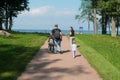 RUSSIA, PETERHOF - AUGUST 20, 2022: Young family walking in the park