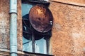 Russia Petersburg August 4, 2020: Rusty satellite dish antenna on the facade of an old building.