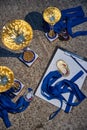 Russia.Petersburg, 05 September 2020: Gold cups and medals of winners expect the delivery, blue ribbons, results of race