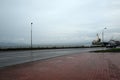 Russia, Petropavlovsk-Kamchatsky: The car goes on the waterfront near the port in the rain Royalty Free Stock Photo