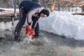 Russia, River Volga Kama - Jan 17th 2020. Man carving an ice hole entry with a motor saw chainsaw for ice scuba diving