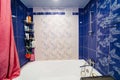 bathroom interior with blue ceramic tiles on the walls.
