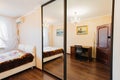 Classic bedroom interior with a large bed, a painting and large mirror cabinet Royalty Free Stock Photo