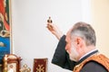 Russia, Rostov-on-Don - May 30, 2014: An Armenian priest holds a bird figurine in his hand and performs the rite of baptism over