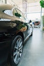 side view. part of a black Mercedes car in the parking of a car dealership