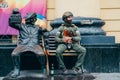 a soldier on a bench with a sculpture of a clown at a circus in Rostov-on-Don