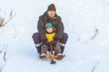 Russia, Ryazan 05 Jan 2019: happy man sliding down hill on snow tubes over winter natural background