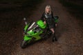 RUSSIA Ryazan, 20.10.2016 - young beautiful girl on a port motorcycle kawasaki zx-10r at the dark road