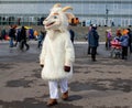 Russia. Rybinsk 1. march. 2020. National holidays and customs. A stuffed goat in the foreground. Masked mummers in the background