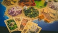 Russia/Saint-Petersburg -30.10.2019: Board game party with my friends. Playing cards. Settlers of Catan popular board game for eve