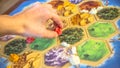 Russia/Saint-Petersburg -30.10.2019: Board game party with my friends. Playing cards. Settlers of Catan popular board game for eve