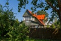 Russia, Saint Petersburg, fox nose. 07.24.2021. an old wooden house with a crimson red roof stands in the middle of trees in the f Royalty Free Stock Photo