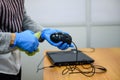 Russia, Saint Petersburg 9 July 2020:Treatment of laptop and mouse with antiseptic-hands in gloves close-up.