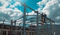 RUSSIA, SAINT PETERSBURG - JULY 10, 2022: The work of builders on the erection of a frame from metal structures