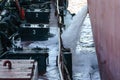 Discharge of ballast water on the deck of an oil tanker in the bay in the port