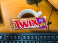 Russia, Saint-Petersburg, 02.10.2020: Twix chocolate and cup tea on the workplace