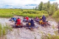 A group of men on quad bikes overcomes water obstacles. Cross-country tours