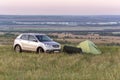 A parking lot at the top of the hill with a view of the steppe valley on a spring day