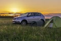 A parking lot at the top of the hill with a view of the steppe valley on a spring day