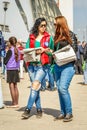 Young beautiful girls give out a free newspaper