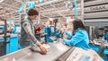 a woman with purchased products is at the cashier`s desk in the supermarket. Royalty Free Stock Photo