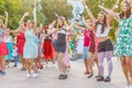 dancing beautiful and elegant stylish girls participating in the carnival costumed women`s bike ride in the summer evening Royalty Free Stock Photo