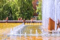 Male guest workers bathe in the fountain pool