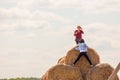 Two girls are photographed on straw bales Royalty Free Stock Photo