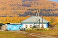 old rustic rural house on the background of the Ural mountain covered with taiga on an autumn sunny day