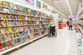 a woman in a wheelchair chooses a book for a child in the children`s department of the store. Royalty Free Stock Photo