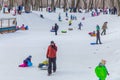 Children ride in a park on a snow hill on a sled Royalty Free Stock Photo