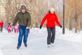 Happy children skating on the ice track in the park