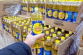 A man`s hand holds a bottle of sunflower oil and chooses in a store.