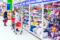 Samara, January 2019: a beautiful mature woman chooses goods in a large supermarket.